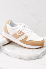 Outside view tan sneakers featuring a canvas body, and a rubber sole