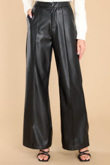 Front view of these pants that feature a high rise, a zipper and hook and eye closure, functional pockets at the hips, a wide leg, and a soft feel inside.