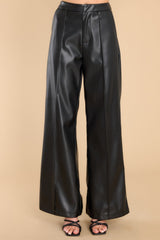 These all black pants feature a high rise, a zipper and hook and eye closure, functional pockets at the hips, a wide leg, and a soft feel inside.