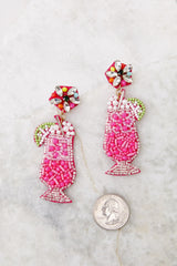 Full view of these earrings that feature pink drink glass with lime and pearl beaded design.