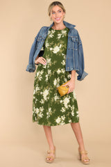 Full body view of this dress that showcases the ivory floral pattern of the green fabric.