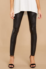 Front view of these faux leather leggings feature a high waisted design, raised stripes on the thigh and calf, and are center seam friendly.