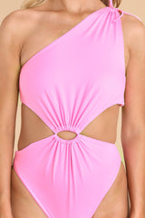 Close up view of this swimsuit that features a one shoulder neckline, adjustable tie on the shoulder, no padding through the bust, cut-outs on the waist, moderate coverage, and a high leg.