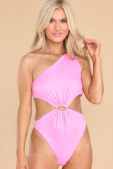 This pink swimsuit features a one shoulder neckline, adjustable tie on the shoulder, no padding through the bust, cut-outs on the waist, moderate coverage, and a high leg.