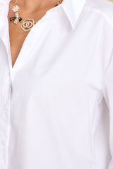 Close up view of this top that features a collared neckline and functional white buttons down the front.