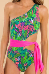 Close up view of this one piece that features a one shoulder, removable pads, cut out on the side, self-tie around the waist, and medium coverage.