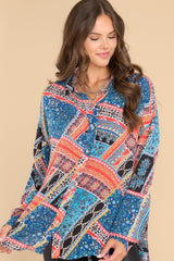 Front view of this top that showcases a bohemian print in shades of orange, blue, and black.