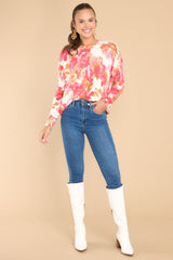 Full body view of this sweater that showcases the floral pattern of the fabric in shades of pink and orange.