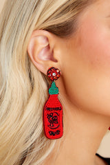 These red statement earrings feature a beaded hot sauce bottle design, sewn details, felt back, and a secure lock back fastening.