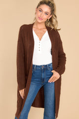 Front view of this cardigan that features an open-front design, long sleeves with tapered cuffs, functional pockets, and a soft knit feel throughout.