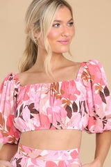 This pink top features a square neckline, puff sleeves and a smocked back.