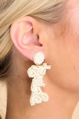 Close up view of these pearl earrings that feature pearl detailing throughout that spells 