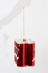 Side view of this ornament that features six red cans with white and gold accents and glitter detailing.