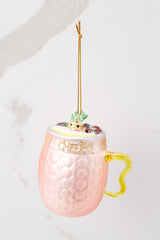 Side view of this ornament that features a drink-like design with glitter writing across. 