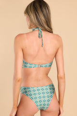 Back view of this bikini top that features a halter neckline that self-ties on the back of the neck, a silver U-shape in between the bust, removable pads, and a clasp lock on the back.