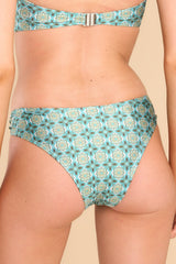 Back view of these bottoms that feature a low rise, a silver U-shape detail on the hips, and low to medium coverage. 