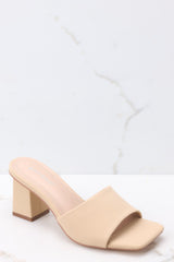 Outer-side view of these heels that feature a square toe, a thick strap across the top of the foot, a block heel, a suede feel, and a slip-on design.