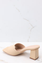Inner-side view of these heels that feature a square toe, a thick strap across the top of the foot, a block heel, a suede feel, and a slip-on design.