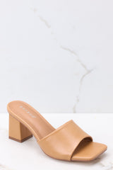 Outer-side view of these heels that feature a square toe, a thick strap across the top of the foot, a square heel, a faux-leather finish , and a slip-on design.