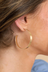 These gold hoop earrings feature a gold finish and a secure post backing.