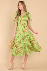 Full body view of this dress that showcases the tan tropical leaf pattern.