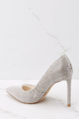 Inner-side view of these heels that feature a pointy closed toe, encrusted rhinestones all over, and a slip on style.