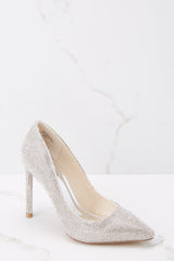 Outer-side view of these heels that feature a pointy closed toe, encrusted rhinestones all over, and a slip on style.