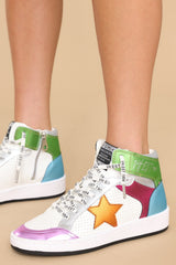 Close up view of these shoes that feature a high top design, multi colors throughout, and additional laces. 