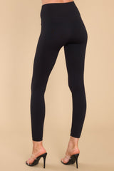 Back view of these leggings that feature a double layered high rise waistband, seamless detailing throughout, and contains stretch.