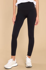 These all black leggings feature a double layered high rise waistband, seamless detailing throughout, and contains stretch. 