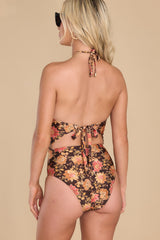 Back view of this one piece that features an adjustable tie around the neck, a keyhole opening in the front, padding in the top, and a black-tie.
