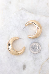 Gold chunky hoops compared to quarter for actual size. Earrings measure approximately 1.5