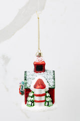 Side view of this ornament that features a barn shape and a silo with trees.