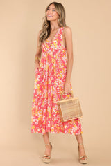 Full body view of this dress that showcases the orange and white floral pattern.