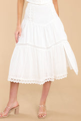 Front view of this skirt that features a functional zipper on the side, a slit up one leg, and eyelet detailing along the bottom.