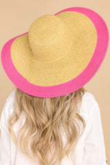 Back view of this hat that features a wide brim, woven material, and a pink color detail along the brim.
