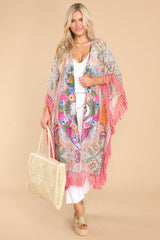 This multi-colored cover up features an open-front style, dolman sleeves, beaded detailing, and tassel detailing along the edges.
