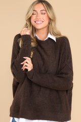 Front view of this sweater that features a mock neckline, bold seam detailing, a ribbed hem and cuffs, and a soft, knit material.