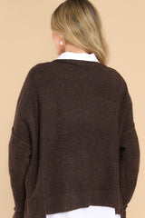 Back view of this sweater that features a mock neckline, bold seam detailing, a ribbed hem and cuffs, and a soft, knit material.