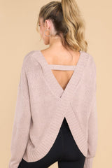 Back view of this sweater that features a scoop neckline, a low v opening on the back, and a opening on the lower back.