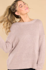 Front view of this sweater that features a scoop neckline, a low v opening on the back, and a opening on the lower back. 