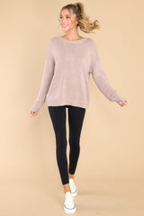Full body view of this sweater that features a scoop neckline and a low v opening on the back.
