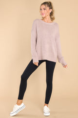 Full body view of this sweater that features a scoop neckline, a low v opening on the back, and a opening on the lower back.