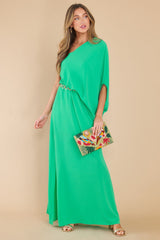 Full body view of this dress that features an off the shoulder neckline, large dolman sleeve, and an elastic waistline.