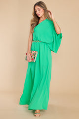 Full body view of this dress that features an off the shoulder neckline and a large dolman sleeve.