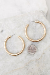Worn Gold Hoop Earrings compared to quarter for actual size. Earrings measure 2