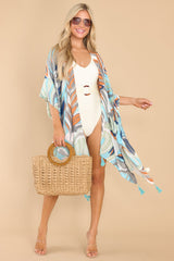 This multi-colored coverup features a wide, flowy fit, has cutouts on the side, tassels on the hem, and a sheer lightweight fabric.