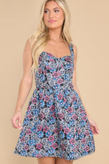 This blue floral dress features a sweetheart neckline, boning throughout the bust, a smock stretch insert on the back, and a zipper on the back. 