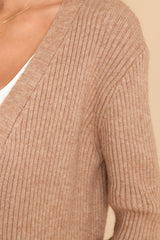 Close up view of this cardigan that features an open-front design, long sleeves with tapered cuffs, functional pockets, and a soft knit feel throughout.