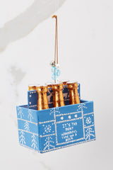 This blue ornament features gold covered bottle tops in a blue box that says 